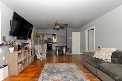 Living area featuring wood finished floors and a ceiling fan
