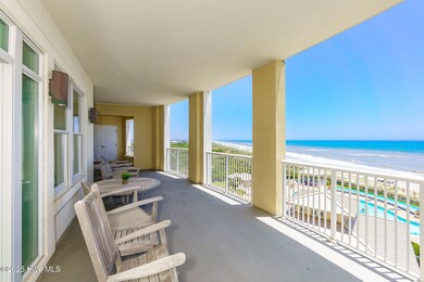 Covered patio overlooking beach and pool