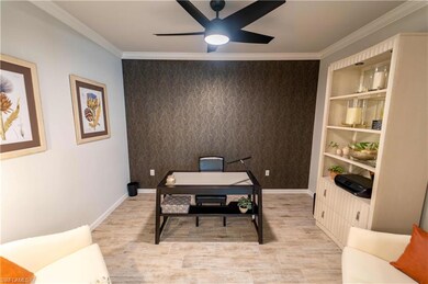 Home office with ceiling fan, built in features, a