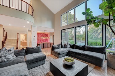Living room with stairs, wood finished floors, and