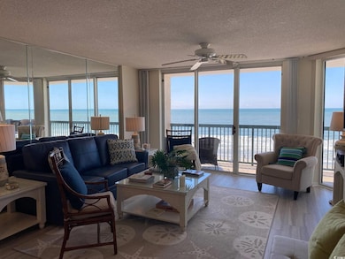 Living area with floor to ceiling windows, a water