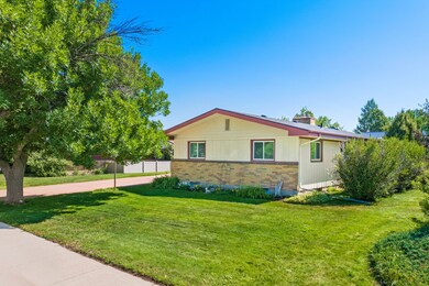 View of front of property with brick siding and a chimney