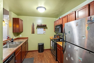 Galley style efficient Kitchen featuring stainless