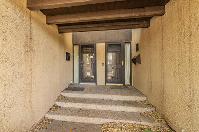 Entrance to property with stucco siding