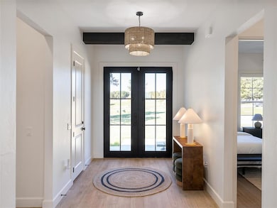 Doorway to outside with wood finished floors and french doors