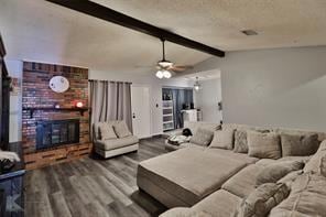 Living room featuring lofted ceiling with beams, a