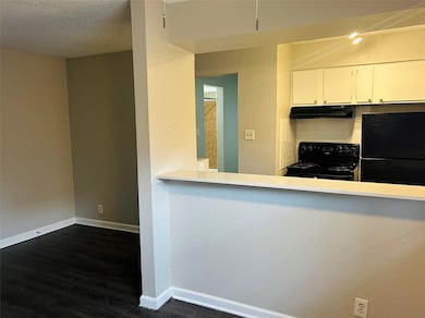 Kitchen featuring black appliances, under cabinet