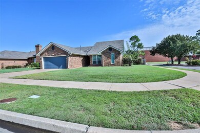 View of front of home with a garage and a front ya
