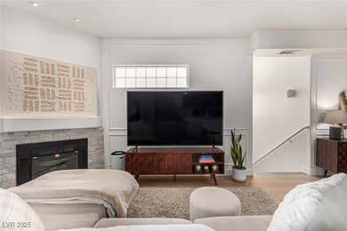 Living room with visible vents, a fireplace, and w