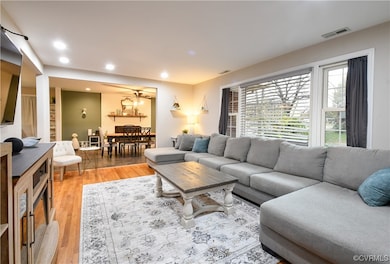 Living room featuring hardwood flooring and a chandelier