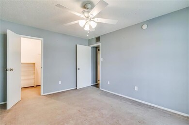 Primary Bedroom w/ walk-in closet and exterior balcony