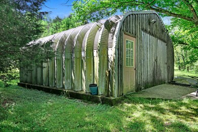 25x25 corrugated steel Kwanzaa building wired for 220, workbench, shop lights & stove.