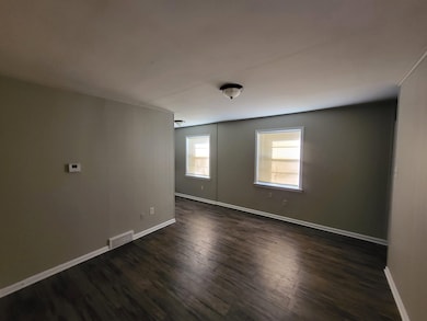 Unfurnished room with dark hardwood / wood-style floors