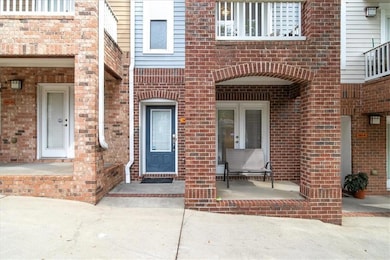 View of exterior entry featuring brick siding
