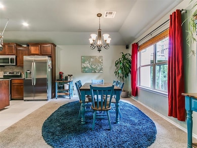 Dining area featuring a chandelier, vaulted ceilin