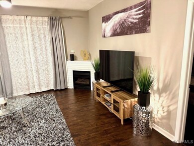 Living area featuring wood finished floors, a fire