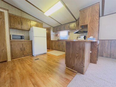Kitchen featuring vaulted ceiling, kitchen peninsu