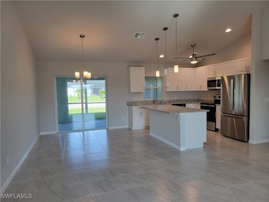 Kitchen with a center island, hanging light fixtur