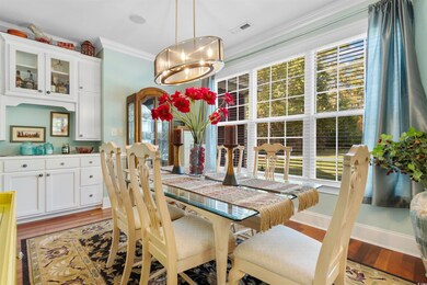 Dining room with an inviting chandelier, crown mol