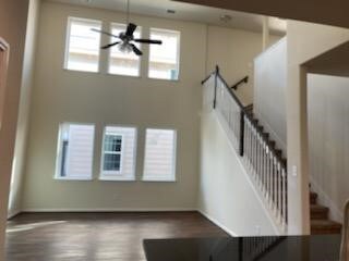 View of the living room and stairs from the foyer