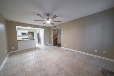 Tiled keeping room opens to kitchen