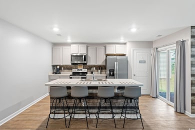 Kitchen featuring a breakfast bar area, stainless 