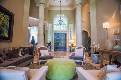 Custom French doors open to the formal living and 