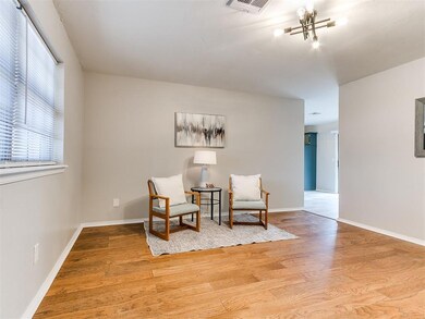 Living area with a notable chandelier and hardwood