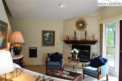 Living area features a stone fireplace with gas lo