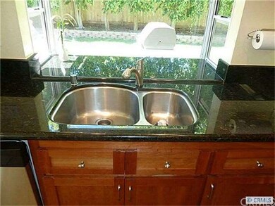 Black granite counters and stainless sinks