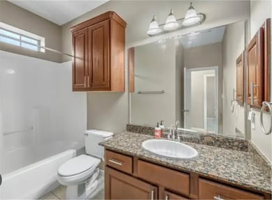 Full bath featuring shower / washtub combination, vanity, and light tile patterned flooring