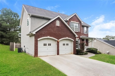 View of front of property with a garage, a front y