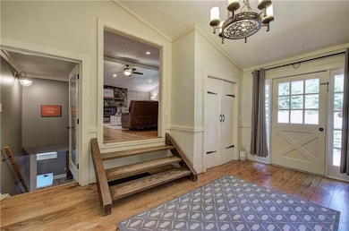 Entryway featuring a wainscoted wall, lofted ceili
