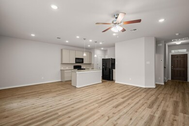 Unfurnished living room featuring baseboards, lig