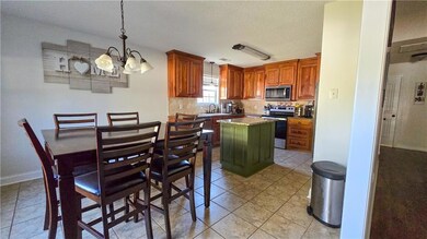 Kitchen featuring an inviting chandelier, stainles