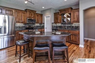 This recent build features custom cabinetry, stainless steel appliances, custom tile backsplash, granite counters and plenty of room for storage.