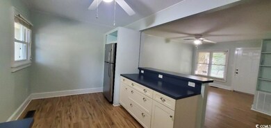 Kitchen with freestanding refrigerator, dark wood-