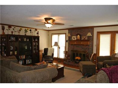Spacious great room with updated ceiling fan, wood
