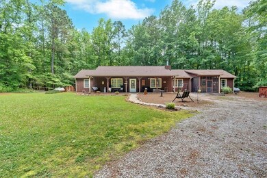 View of front of house with a sunroom and a front yard