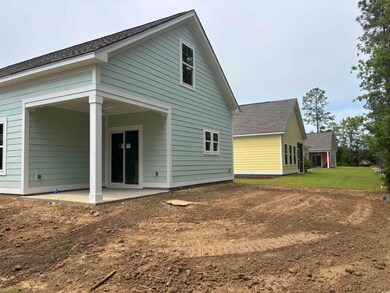 Back of property featuring a patio area, a shingled roof, and a lawn