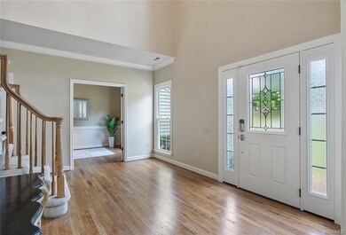 Two story foyer flanked by office and formal livin