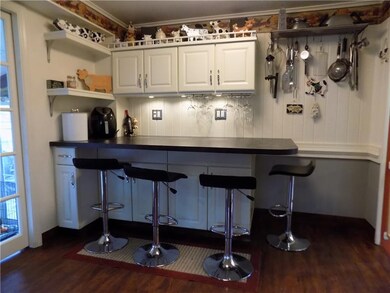 Kitchen eat-in area is great for dining and entertaining.  Paneled walls and chair rails create a welcoming farmhouse look.
