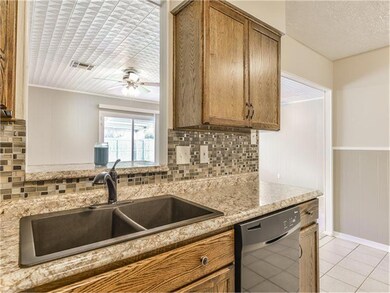 Stay connected with the entire family with the large window above the updated sink.