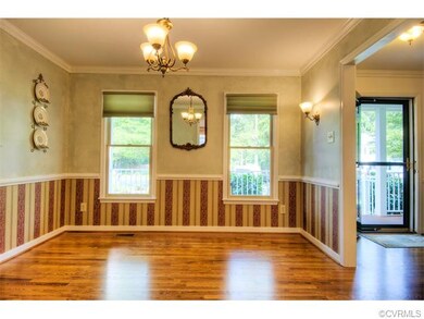 The formal dining room is large and features hardw