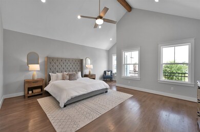 The primary bedroom stands out with its impressive cathedral ceiling, which adds an element of grandeur and spaciousness to the room. A robust cedar beam adds a rustic touch and creates visual intrigue.
