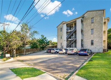 View of property featuring uncovered parking
