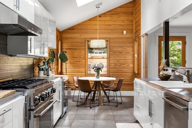Kitchen featuring under cabinet range hood, appli