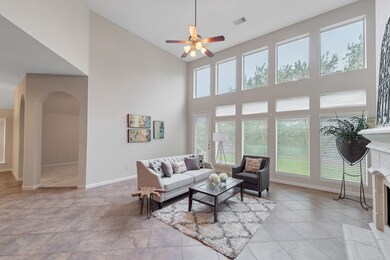Soaring ceilings in the family room are enhanced by a wall of windows which flood the room with light.  Beautiful, low maintenance tile floors are found throughout the casual living areas.