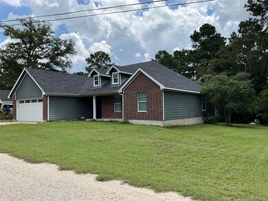 View of front of property with brick siding, a front lawn, and a shingled roof