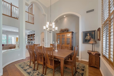 The formal dining room showcases dramatic 20-foot